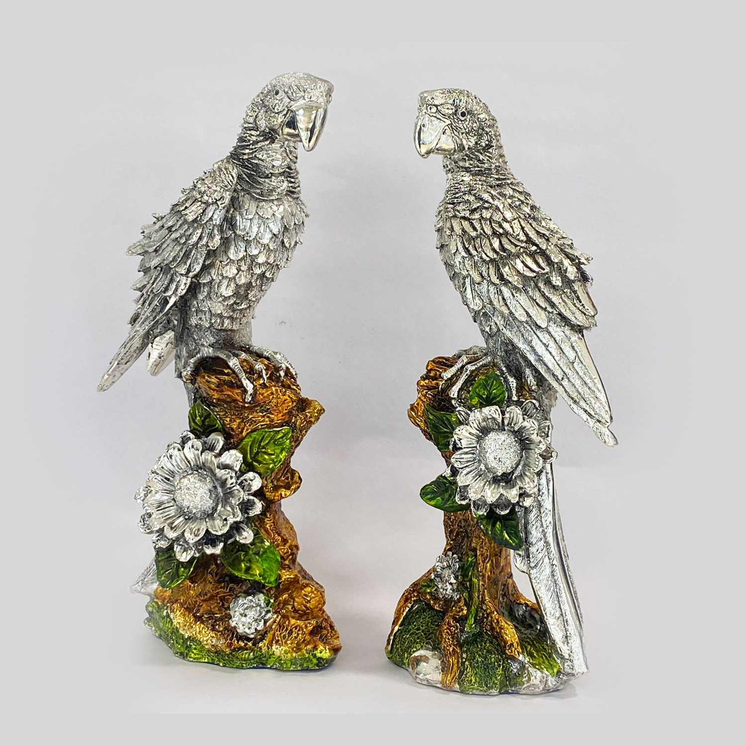 a Artistic Silver Parrots Pair sitting on a tree Trunk. 11.5″ | Resin Silver