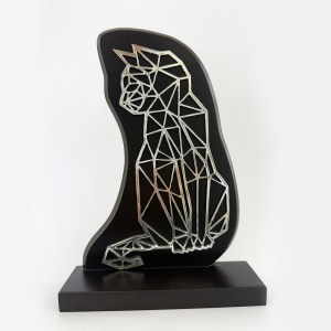 Geometric wire-frame sculpture of a seated dog on a black curved backing, mounted on a square base.