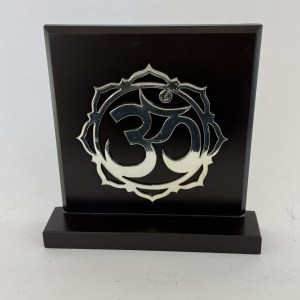 Black wooden plaque with a circular ornate silver emblem centered on it, mounted on a matching base.