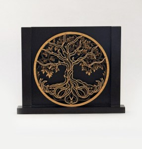 Circular wooden tree-of-life cutout mounted on a black display box.