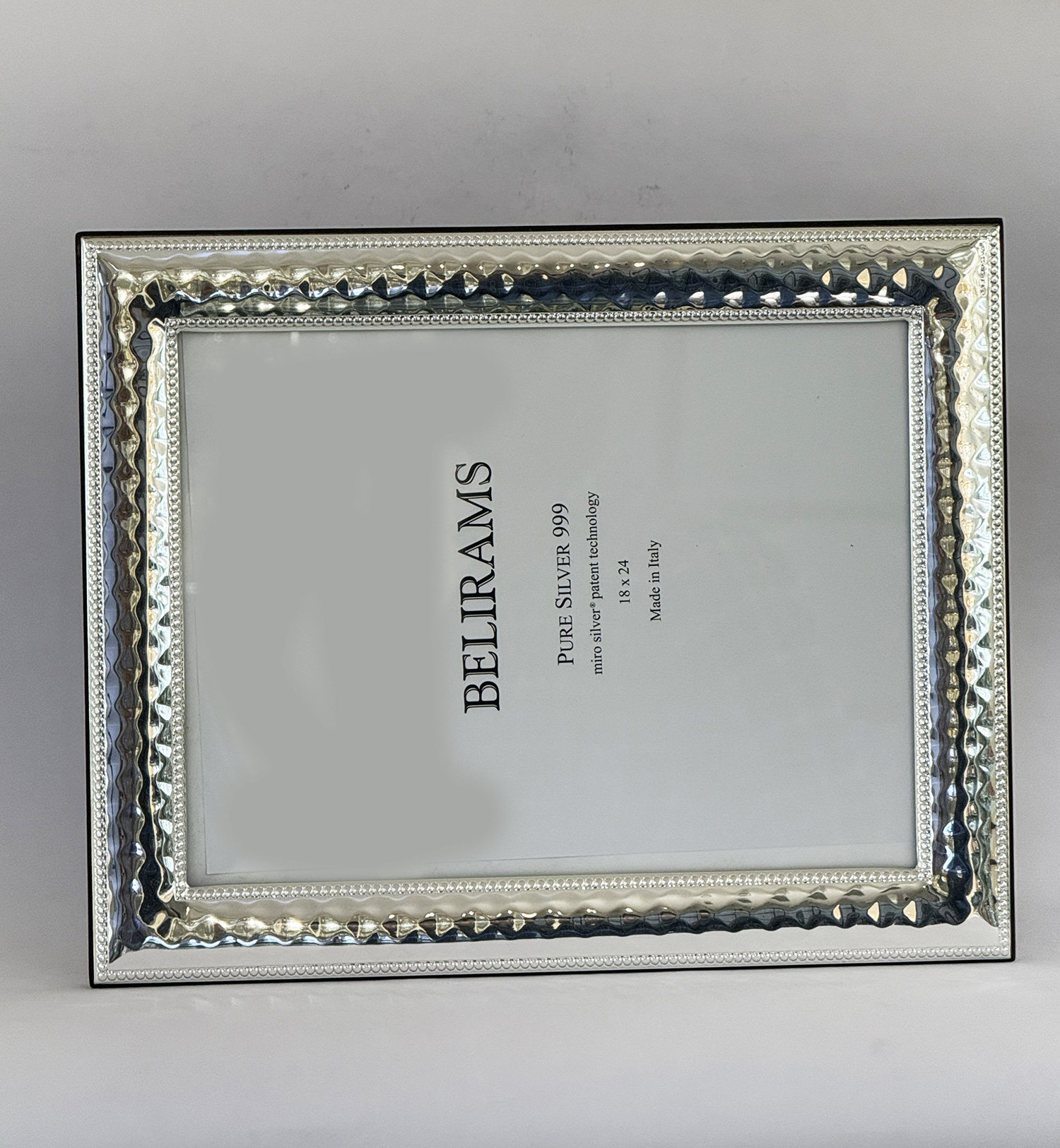 Decorative silver-toned rectangular frame with a hammered, beaded border and glass center, showing a paper insert with 'PURE SILVER 999' text inside.