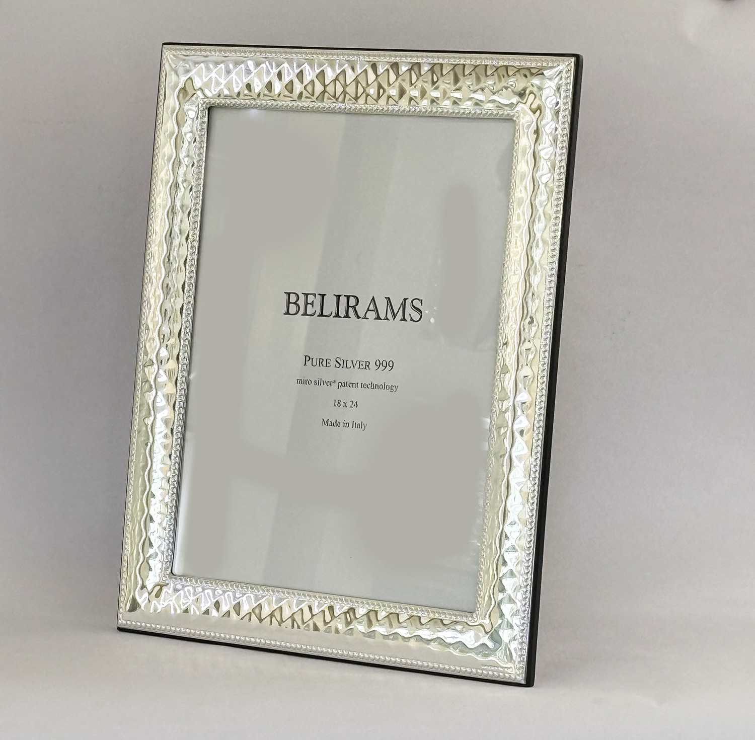Ornate silver picture frame with a white insert reading 'BELIRAMS' and 'Pure Silver 999' text