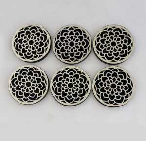 Six round metal coasters with a detailed lacy florals cutout, arranged in two rows.]?