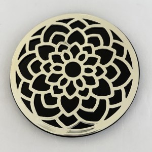 Round decorative metal plate with a layered white floral rosette cutout pattern against a black background, wall decor.