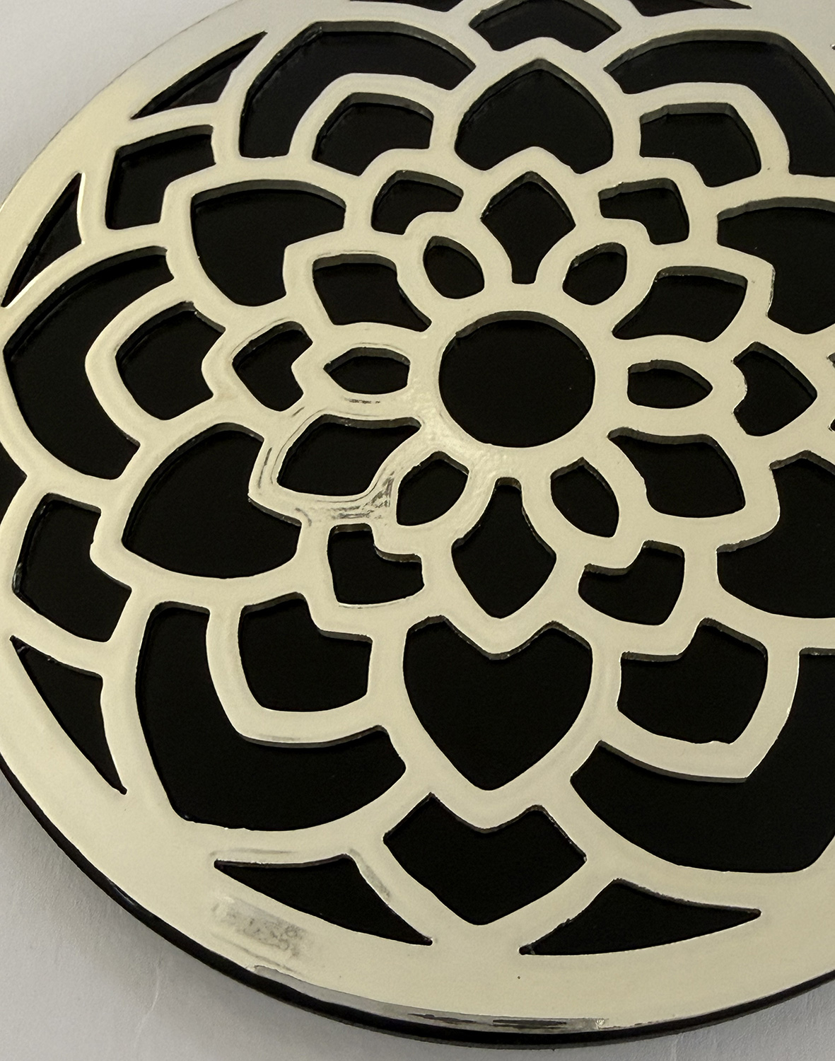 DX-CSA-2c Circular decorative wall art with a layered white flower-petal pattern on a black background.
