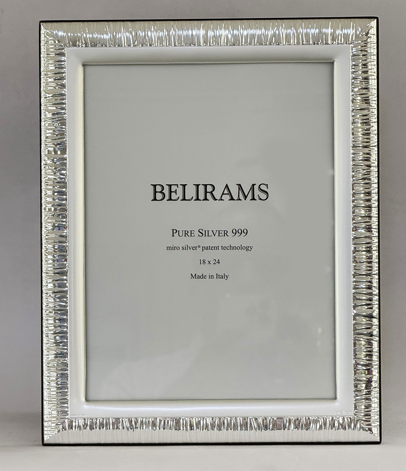 Framed display showing BELIRAMS Pure Silver 999 plaque with 18 x 24 dimensions, Made in Italy, surrounded by a textured silver frame