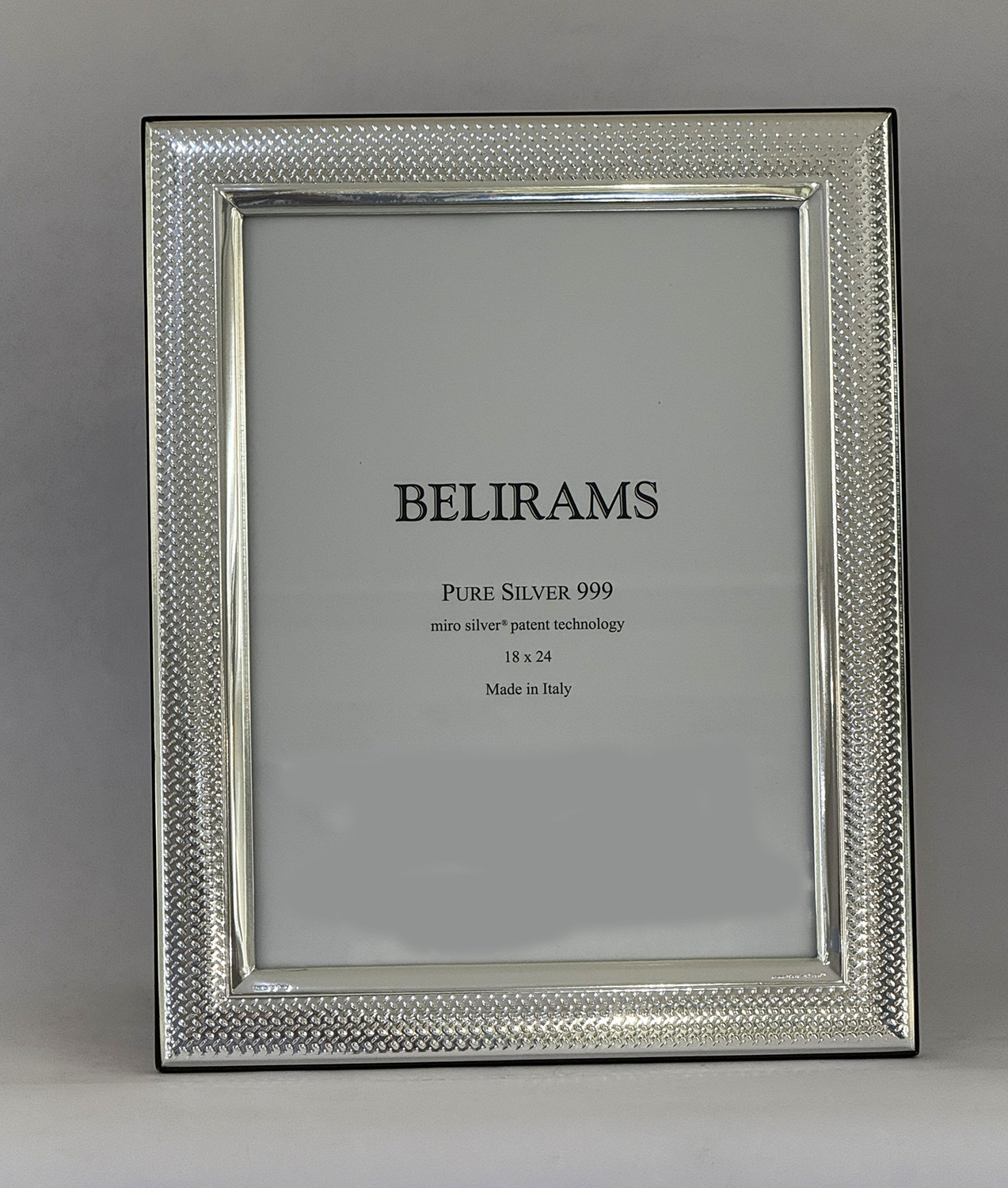 Silver textured picture frame holding a white insert that reads BELIRAMS Pure Silver 999, Made in Italy.