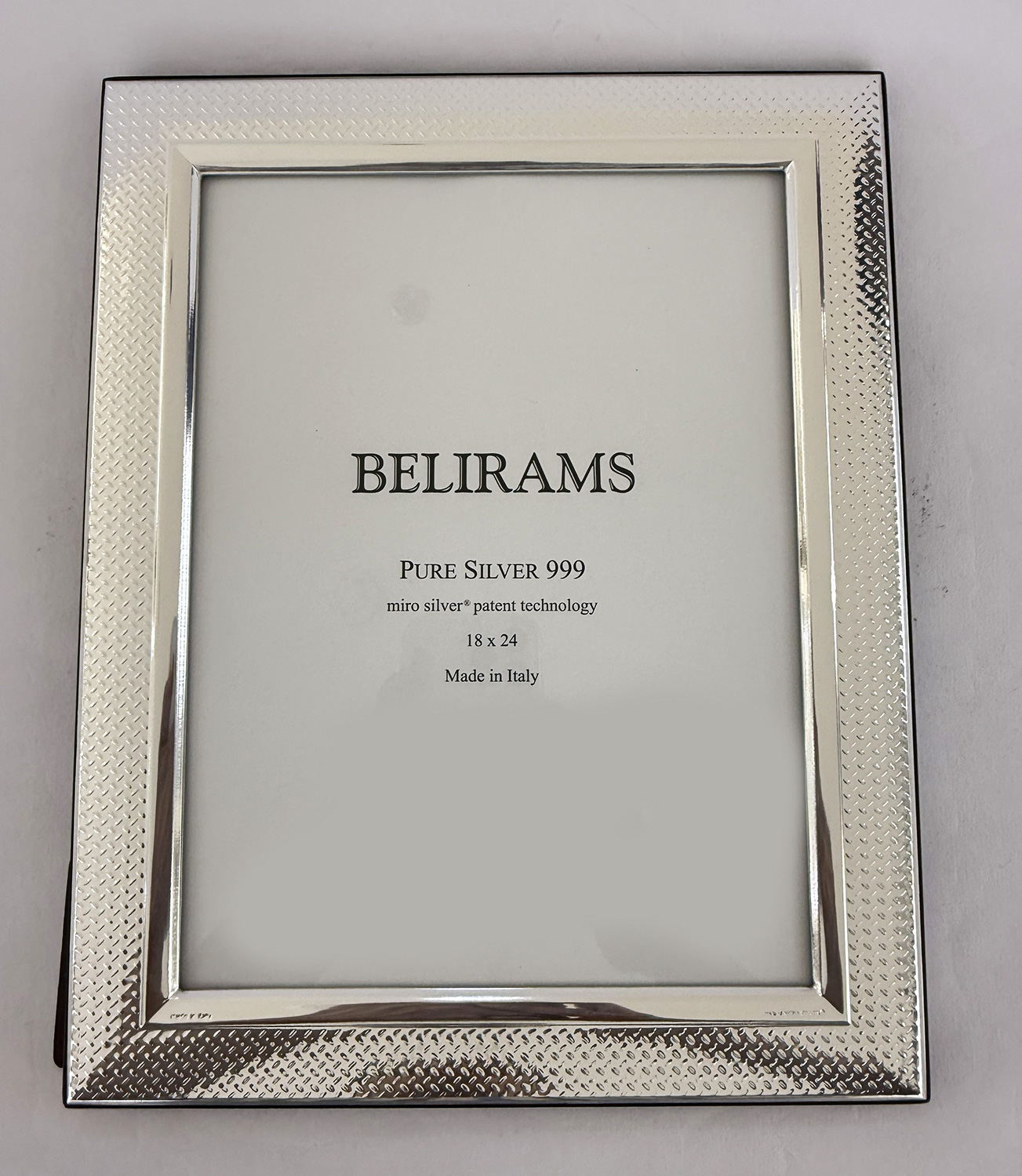 Silver textured picture frame with inner bevel and a display card reading BELIRAMS Pure Silver 999, Made in Italy.
