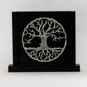 Circular metal Tree of Life sculpture mounted on a black display against a light background.