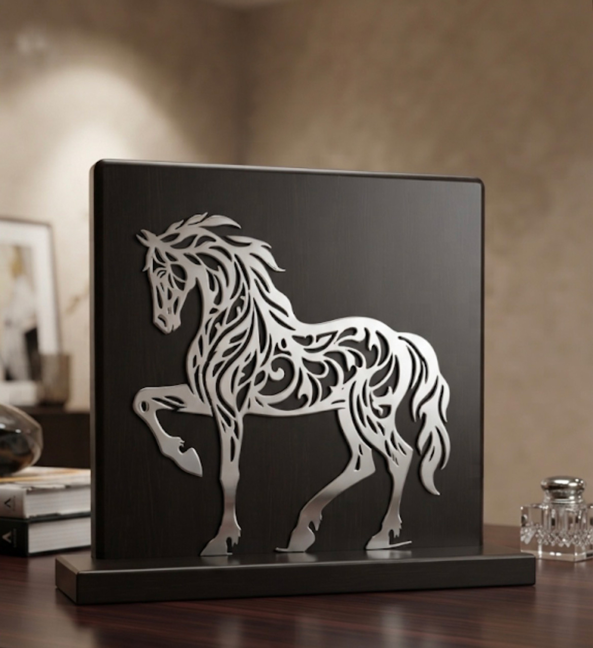 Decorative black panel with a silver cut-out silhouette of a rearing horse on a wooden table surface.